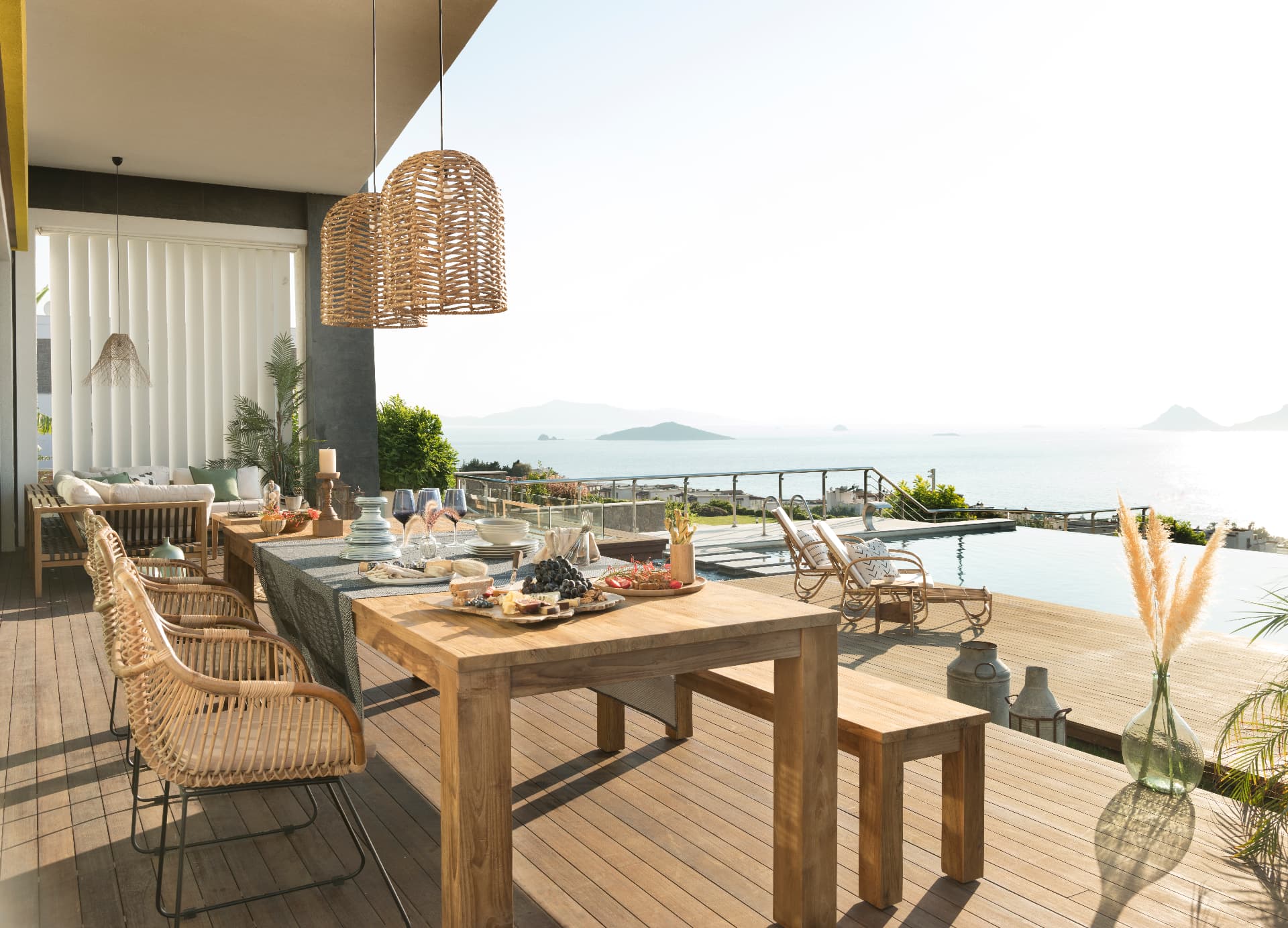 Outdoor chef's table on a villa terrace overlooking the Aegean sea
